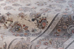 What Does “700-Reed” Actually Mean? In the world of machine-made carpets, the term “reed” refers to the number of knots per meter along the width of the carpet. A 700-reed carpet has 700 knots across each horizontal meter, resulting in finer, more intricate designs and a denser weave. This level of detail closely mimics handwoven carpets, making them ideal for high-end commercial and religious spaces such as mosques, prayer halls, and cultural centers. It’s important not to confuse “reed” with “density,” which refers to the total number of knots per square meter, another important quality marker. Reference: "Textile Construction Principles" by Dr. S. Mohammadi, Kashan University of Textiles, 2016 How to Recognize Real Acrylic Yarn in Carpets Genuine 700-reed carpets are typically made with 100% heat-set acrylic yarn. This material offers wool-like softness, better resilience to crushing, and strong color retention. If you're touching the surface and it feels too slippery or overly glossy, it might be polyester or a blend, not pure acrylic. Acrylic yarns also tend to bounce back after pressure, making them suitable for high-footfall areas such as mosques and hotels. Manufacturers like Pamchal Carpet Company often provide certification on yarn composition for export documentation, especially for Arab clients who value long-term durability. Examining Thickness, Weight & Overall Build While design and softness are important, physical structure matters just as much. Authentic 700-reed carpets typically weigh between 3.2–4.1 kg per square meter. Their pile height is usually between 7 to 11 mm, with a well-defined backing that gives the carpet stability. Counterfeit or downgraded products often cut costs by reducing pile height or using inferior weft yarns, resulting in lighter, thinner carpets that wear out faster. Always ask for technical data sheets from the supplier to confirm specifications. Visual Precision – A Marker of Authenticity One of the standout features of true 700-reed carpets is their visual clarity. With more knots per meter, designs appear sharper and more layered. If you see blurred outlines, flat patterns, or misaligned borders, the rug may not be a real 700-reed item. This visual distinction is crucial for projects like mosque interior decoration, where symmetry and elegance are non-negotiable. Labels, Certificates, and Country of Origin Professional exporters and buyers should never rely on visuals alone. Authentic 700-reed carpets should come with detailed product labels showing reed count, material type, origin (e.g., Made in Iran), and batch number. Leading Iranian brands like Pamchal Carpet, based in Kashan, are known for transparent documentation and standardized labeling, especially when supplying to the UAE, Saudi Arabia, and other Gulf countries. Insider Tip for Bulk Exporters Before making a large purchase or signing a supply contract, request a sample and conduct durability tests, such as colorfastness, flame resistance, and weight per square meter. Collaborating with ISO-certified factories like Pamchal ensures smoother customs clearance and higher satisfaction for your end clients. Conclusion: Identifying a genuine 700-reed acrylic carpet is a skill every importer or distributor should master. It requires knowledge of structure, materials, craftsmanship, and export documentation. By working with established Iranian manufacturers and checking all technical specs, you protect your investment and ensure long-term satisfaction for your clients in the Arab and global markets. Contact Pamchal Company Today